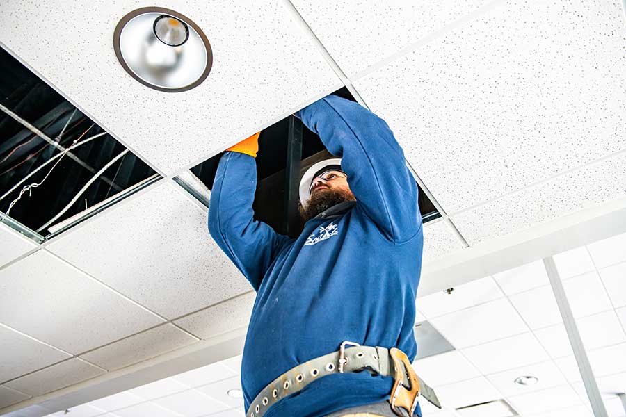 Commercial electrician servicing electrical systems